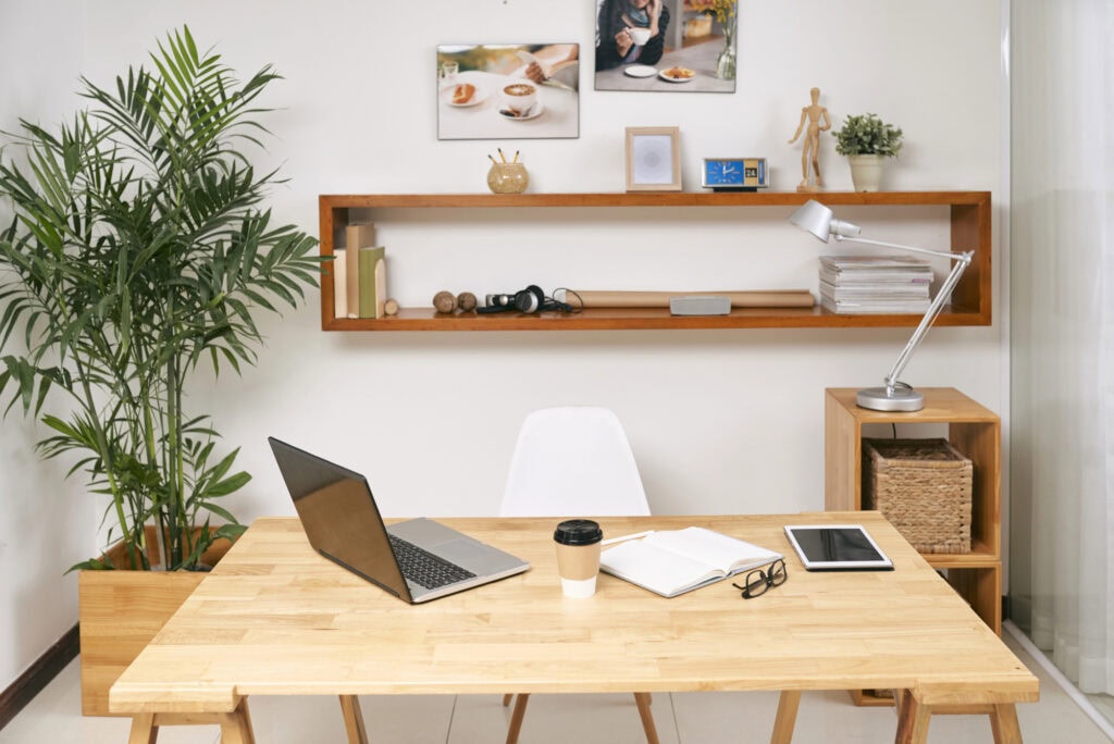Opened laptop, digital tablet, planner and cup of coffee for article about the easiest work at home jobs that require no experience